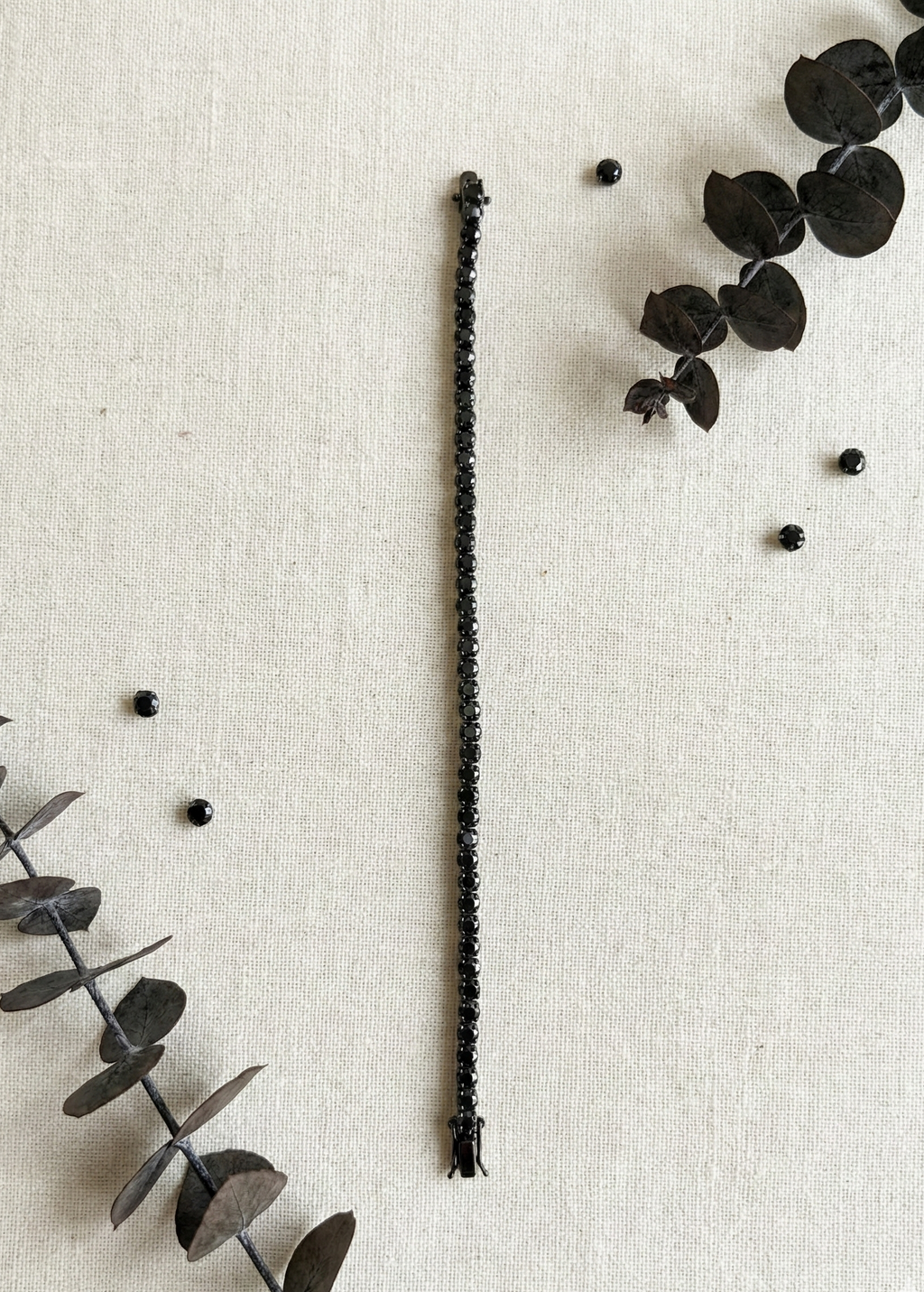 Unisex Black Diamond Tennis Bracelet 925 Silver flat lay on beige background