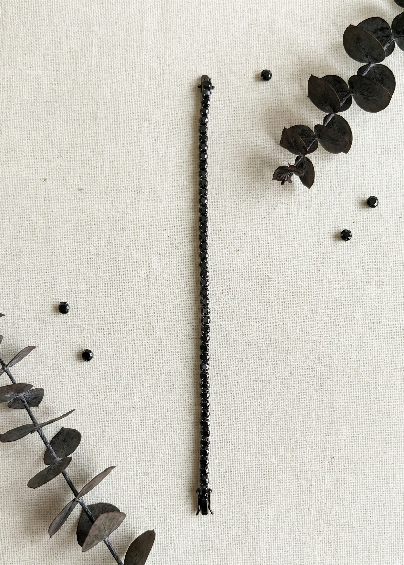 Unisex Black Diamond Tennis Bracelet 925 Silver flat lay on beige background